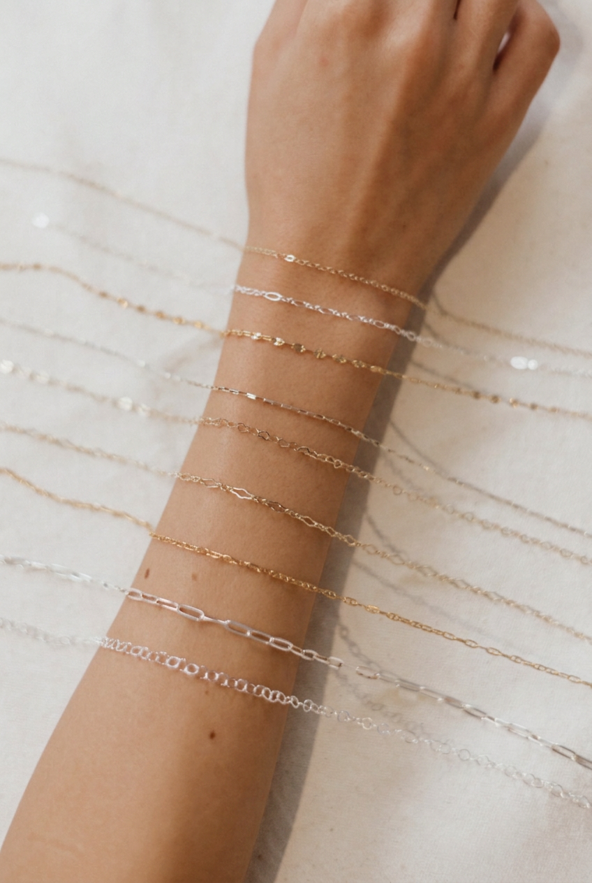 Gold and silver chain styles laid across a forearm